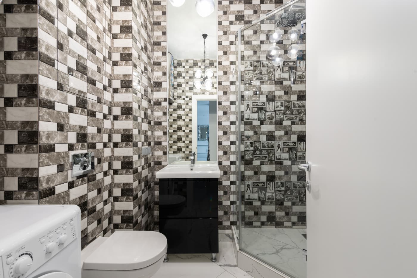 A plain apartment shower fitting on a tiled wall, photographed straight on